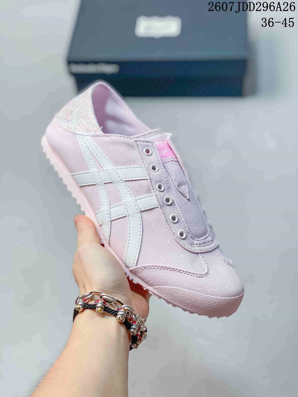 Light pink Onitsuka Tiger Mexico 66 slip-on sneaker with white side stripes and a pink outsole.