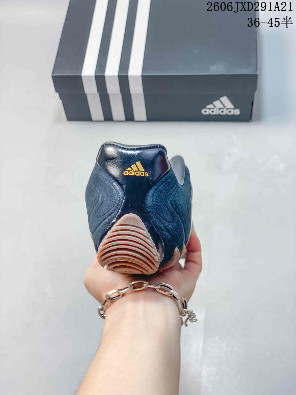 Rear view of the dark navy sneaker showing the padded heel and tan outsole section.