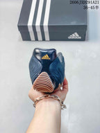 Rear view of the dark navy sneaker showing the padded heel and tan outsole section.