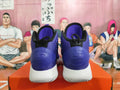 Rear view of purple Nike high-top basketball shoes with black details and white soles