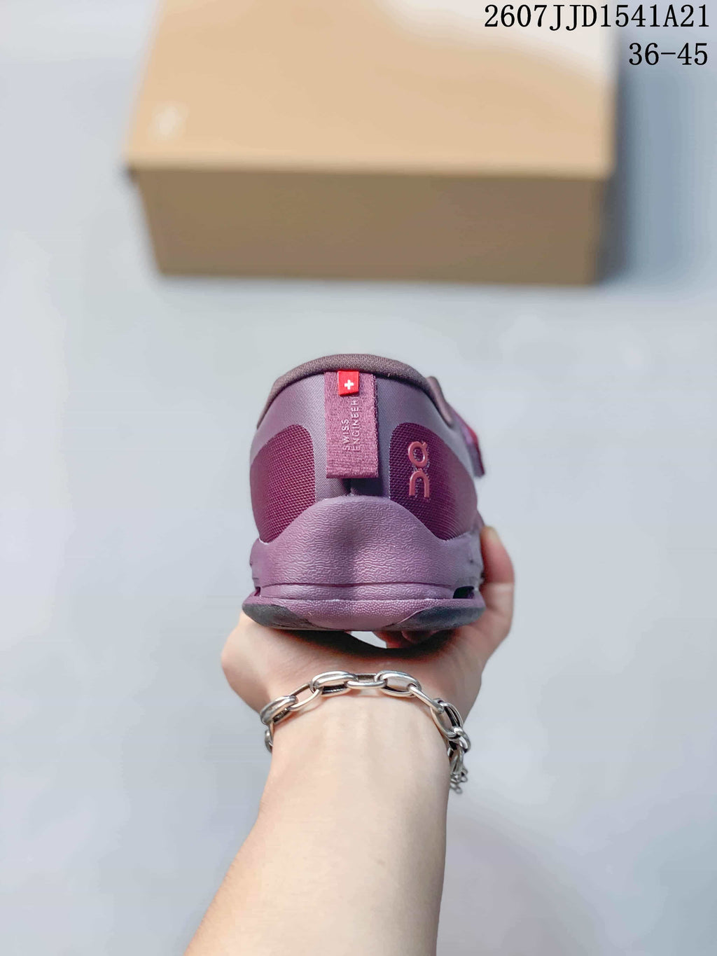 Rear view of a purple and red On Cloudnova sneaker showing the padded heel and vertical On branding.