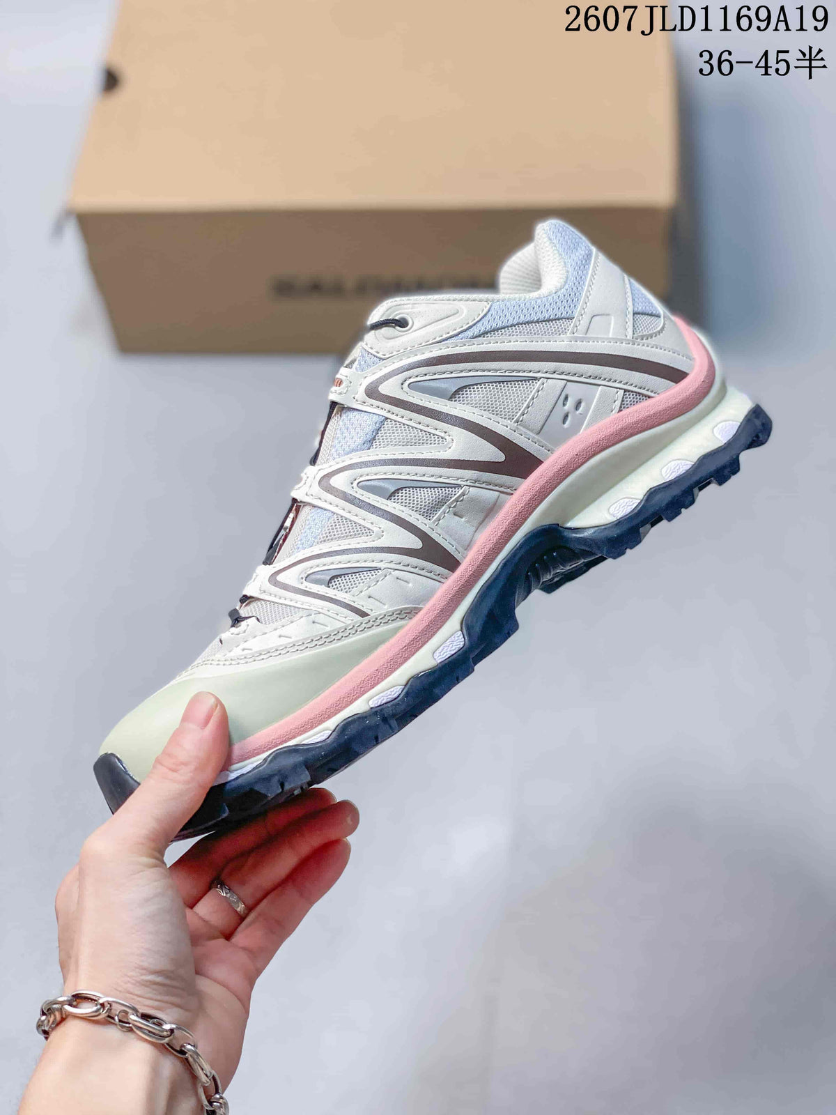Side view of a Salomon XT-Quest sneaker showing the layered upper, pink midsole accent and dark outsole.