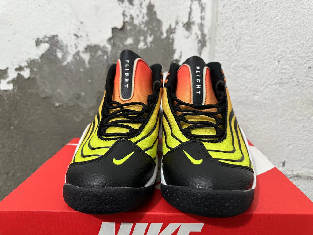Front view of gradient yellow and orange Nike shoes with black laces and toe panels.