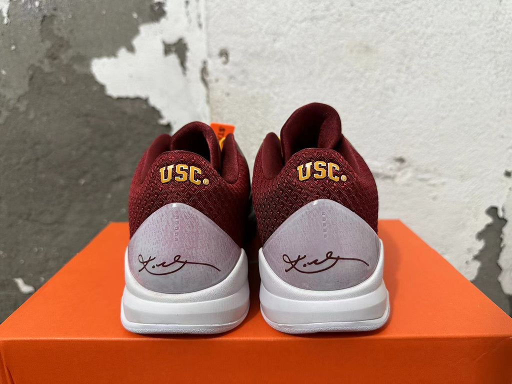 Rear view of burgundy Nike Kobe shoes with USC lettering and signature heel panels