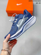 Side view of the navy sneaker showing the white Swoosh, layered upper panels, and white midsole.