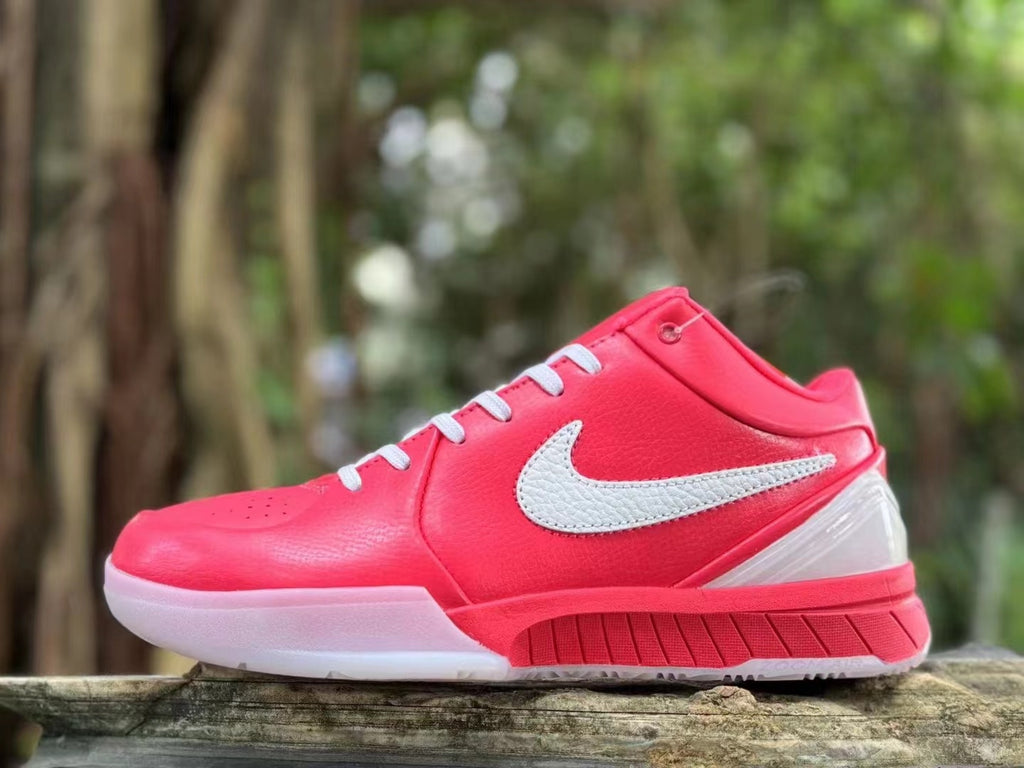 Side profile close-up of a pink Nike Kobe 4 shoe with white details.