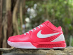 Side profile close-up of a pink Nike Kobe 4 shoe with white details.