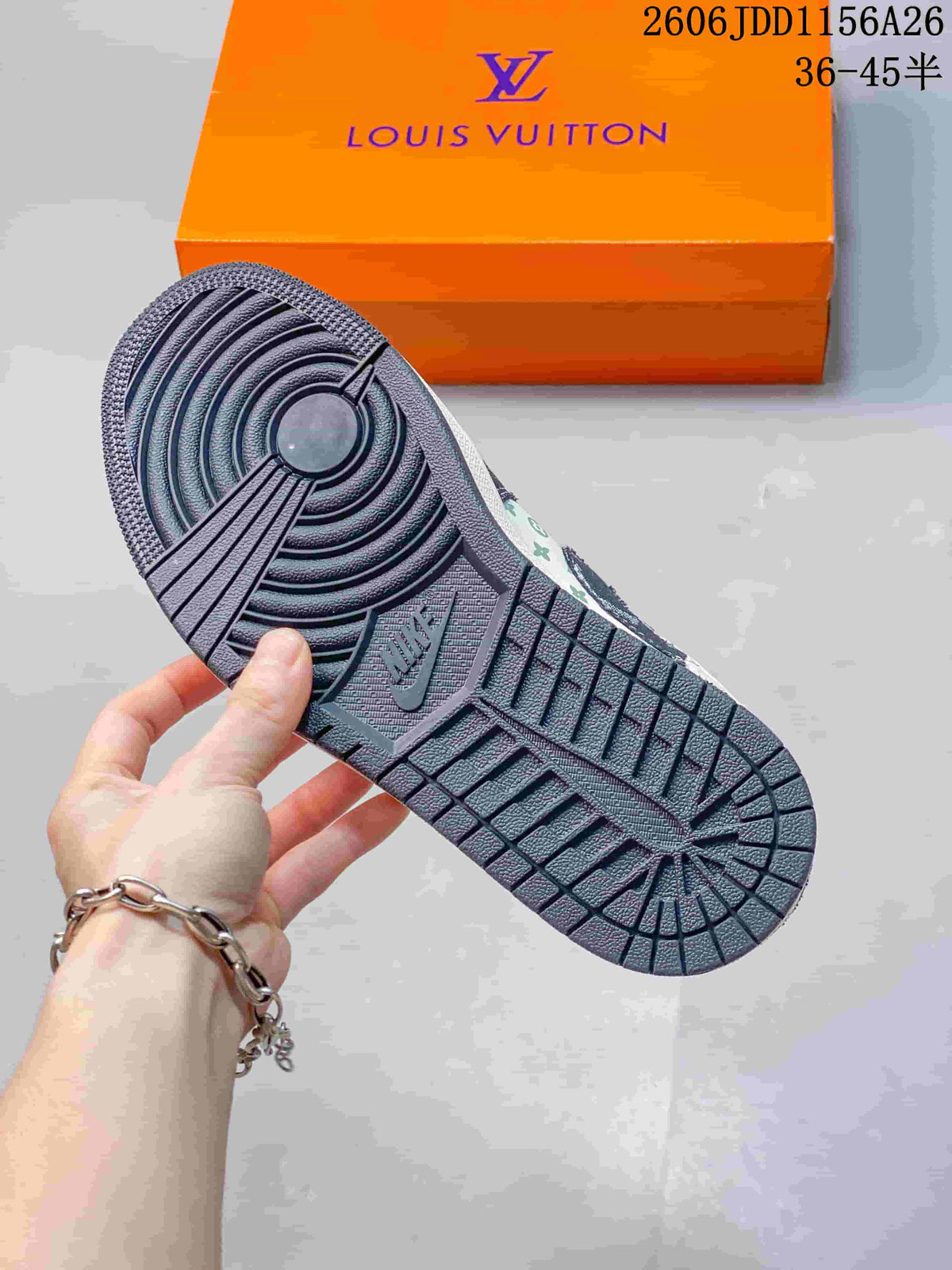 Close view of the dark textured outsole and circular traction pattern, with the orange box in the background.