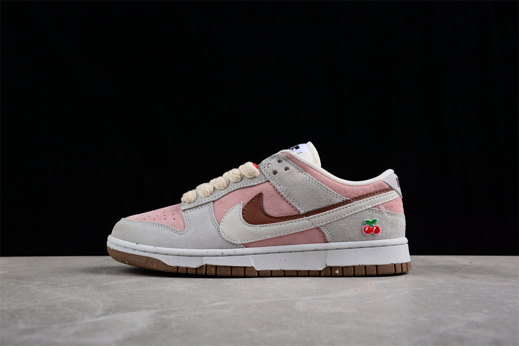 Opposite side profile showing the low-top construction, layered Swoosh, pink panels, and cherry embroidery.