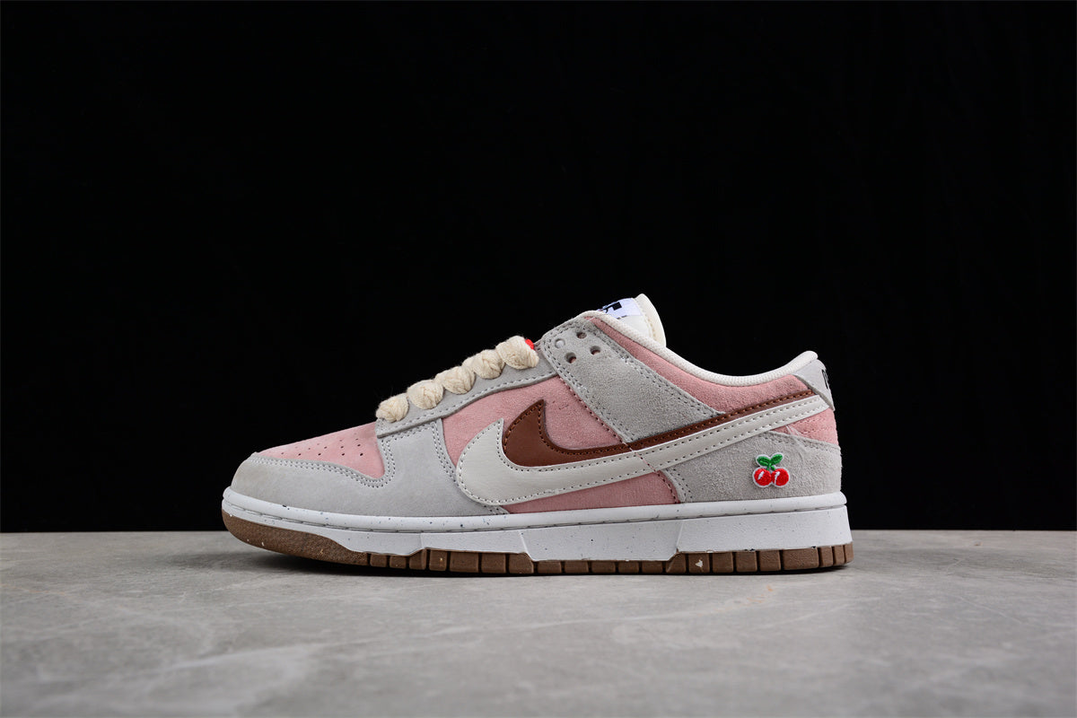 Opposite side profile showing the low-top construction, layered Swoosh, pink panels, and cherry embroidery.