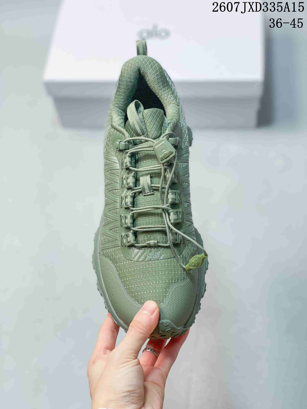 Top view of the green sneaker showing the patterned upper, tongue, quick-lacing system, and toggle detail.