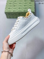 Side view showing the white upper, patterned collar trim and thick rubber sole.