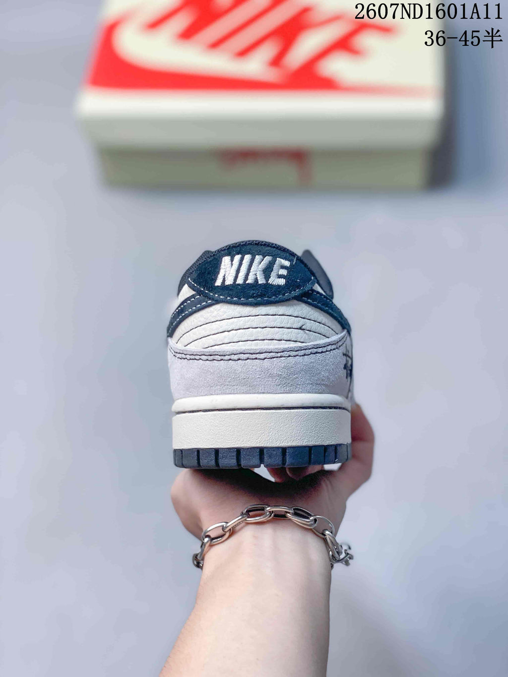 Rear view of the sneaker showing the navy heel collar, layered heel construction, and Nike branding.