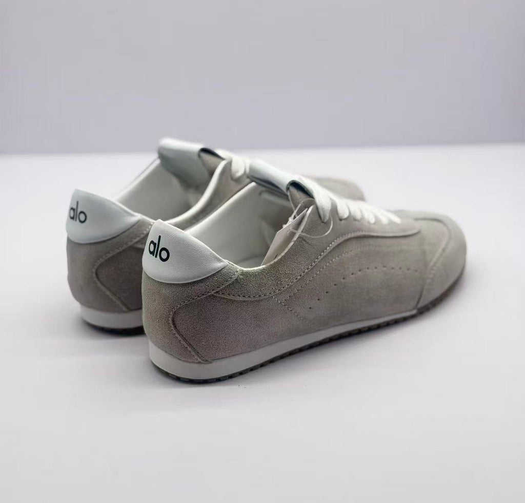 Rear three-quarter view showing the gray heel panels and white Alo-branded heel details.