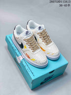Pair of white Nike Court Vision sneakers with black Swooshes, beige laces, colorful graffiti artwork, and a turquoise Nike shoebox.
