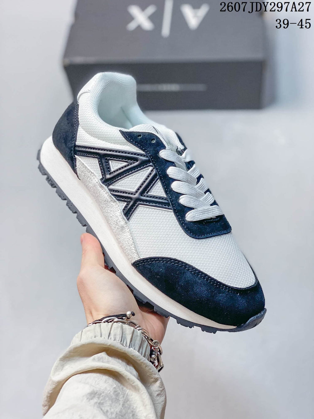 Angled side view highlighting the navy side logo detail, white upper, and low-top silhouette.