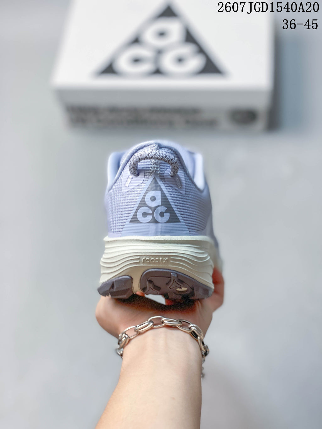 Rear view of the sneaker showing the ACG heel logo, padded collar, layered midsole, and outsole tread.