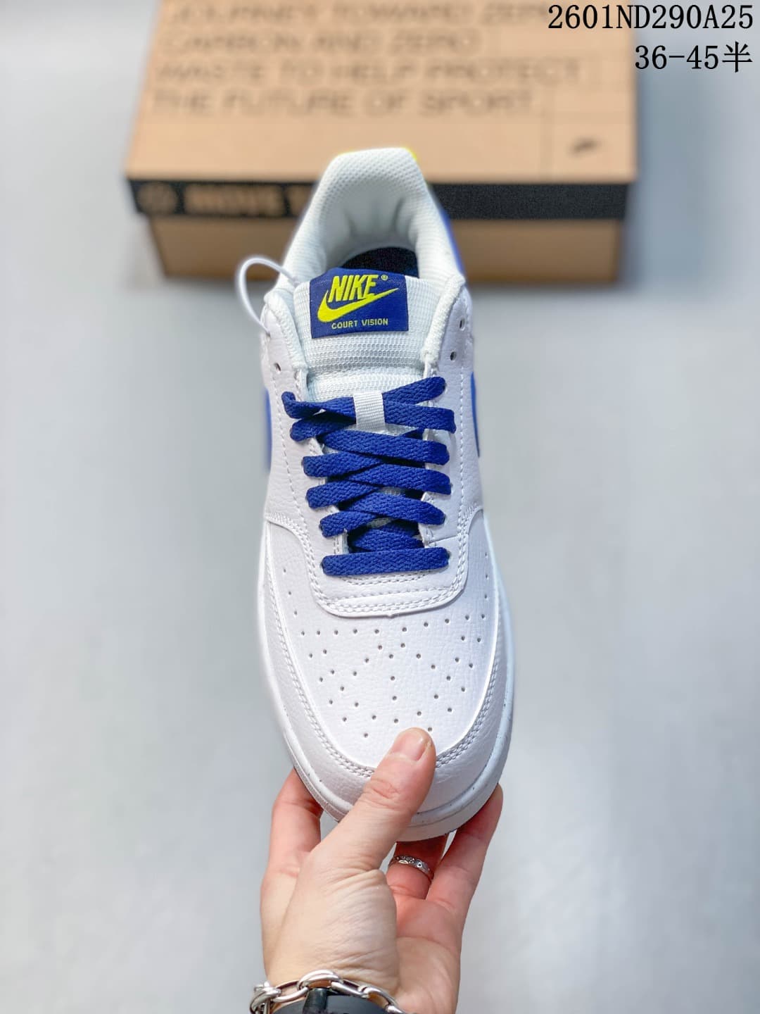 Top view showing the perforated white toe box, blue laces, and Nike Court Vision tongue label.