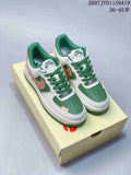 Pair of white, green and tan Nike Air Force 1 '07 low-top sneakers displayed on a shoebox.