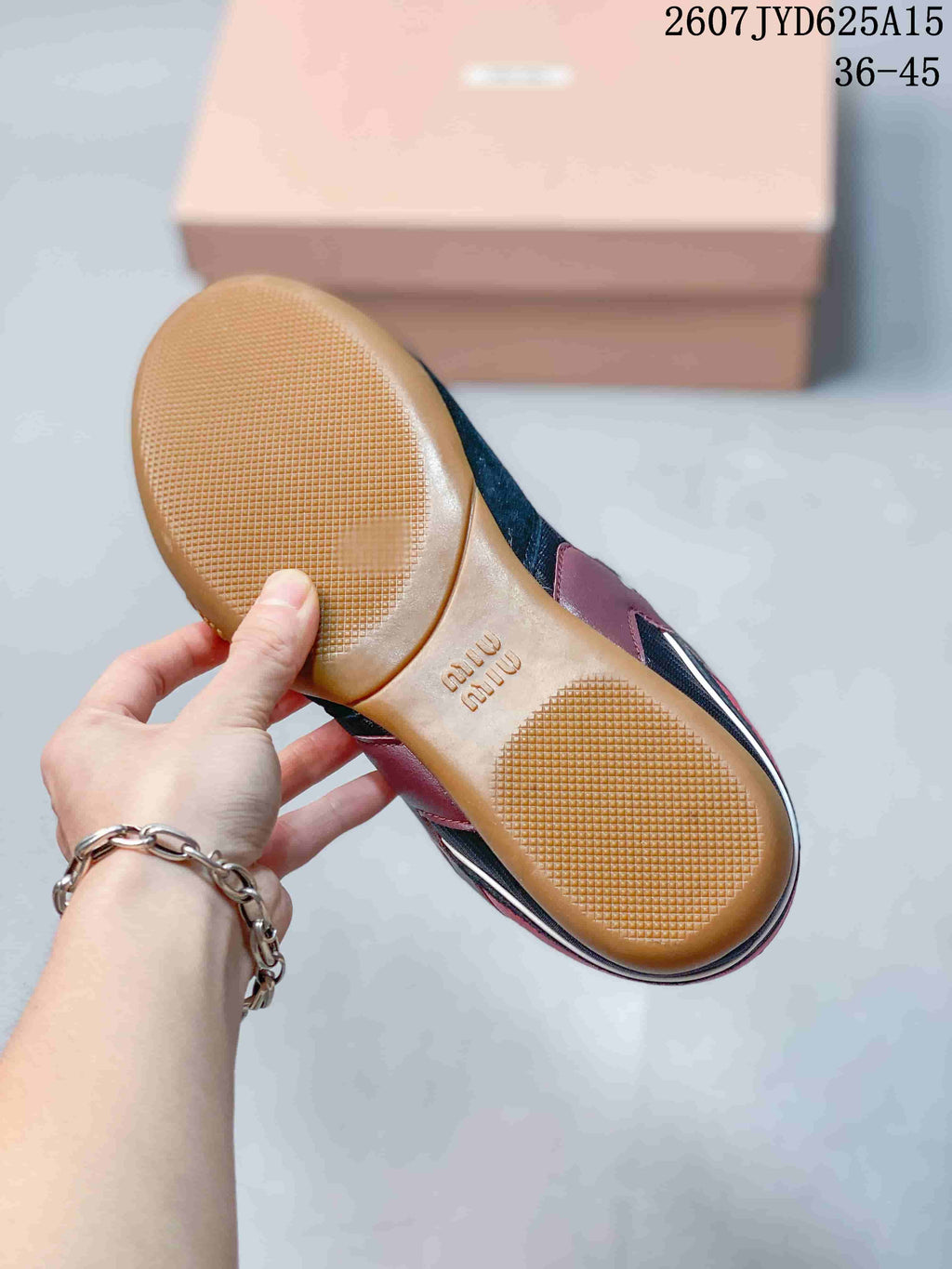 Close view of the gum-colored outsole showing textured traction areas and embossed branding.