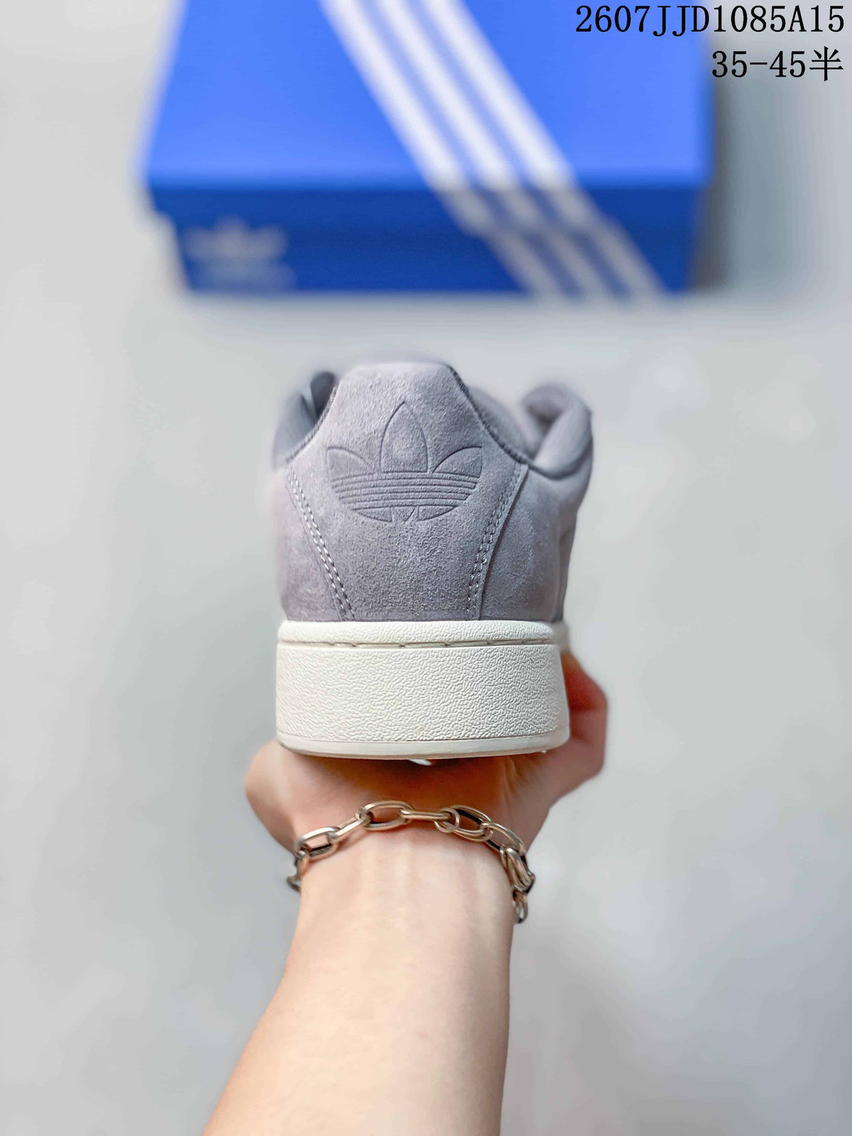 Rear view of the grey sneaker showing the embossed trefoil logo and thick off-white heel sole.