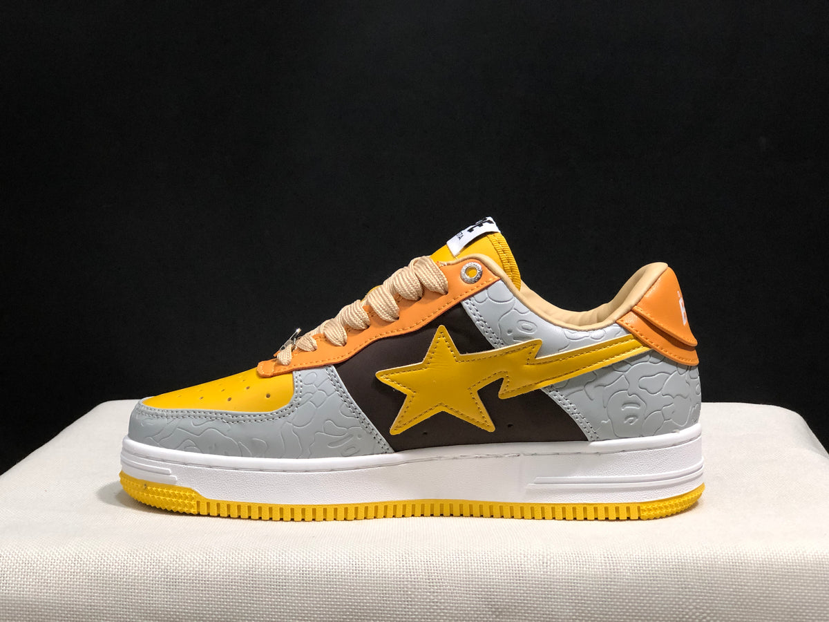 Side profile showing the low-top shape, star side detail, embossed grey panels, and yellow outsole.