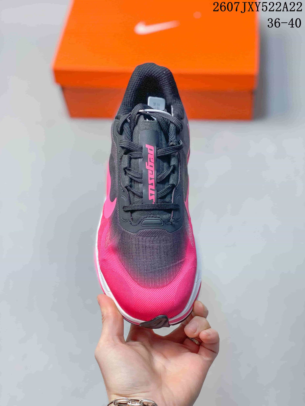 Top view showing the black tongue and laces, pink toe area, and textured upper.