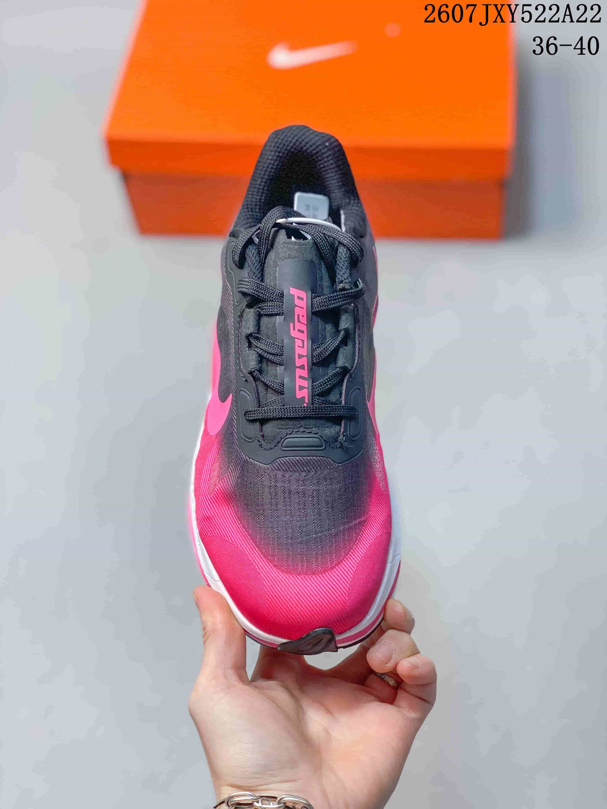 Top view showing the black tongue and laces, pink toe area, and textured upper.