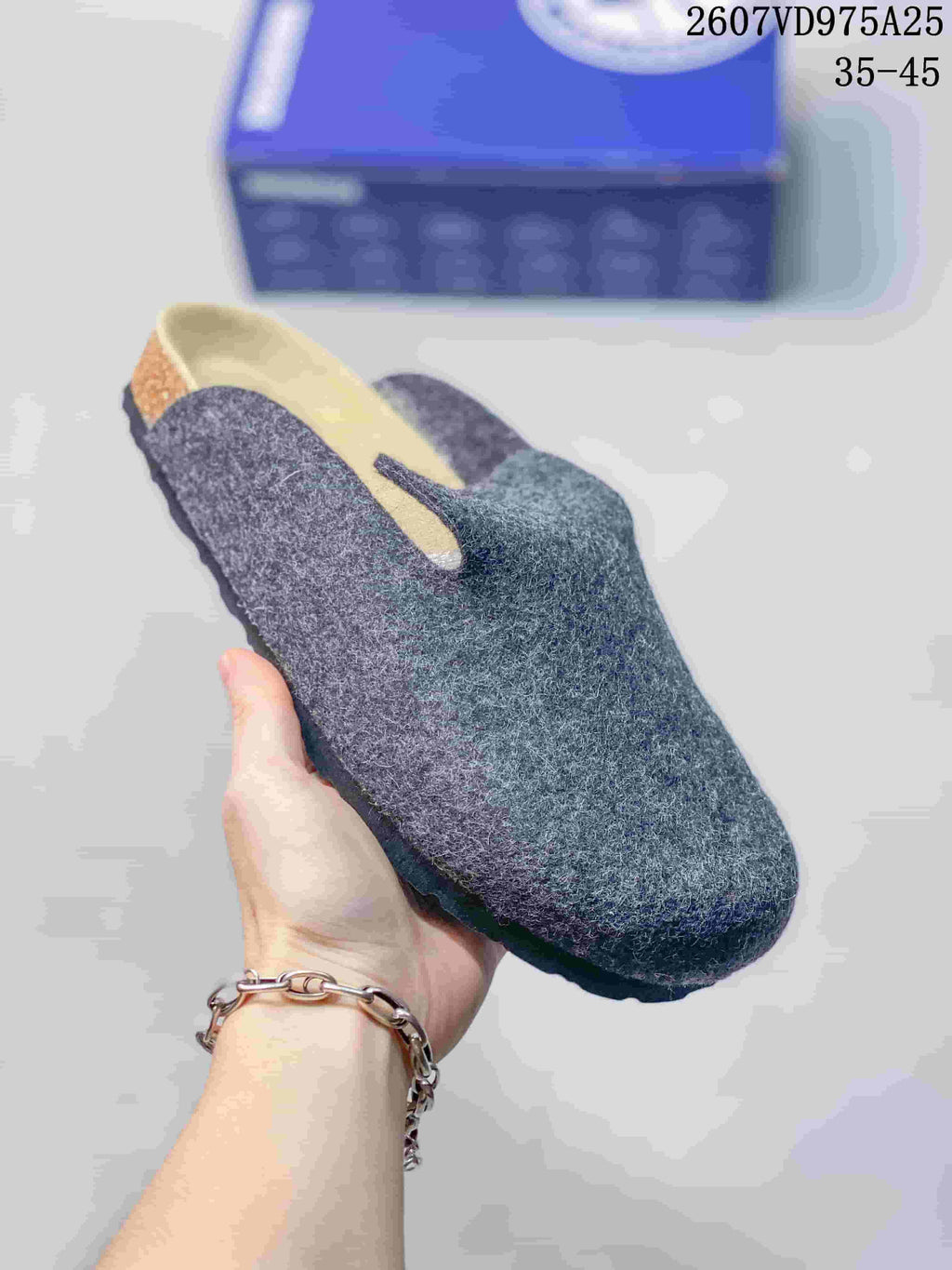 Close-up of a gray-blue textured clog showing the closed toe and contrasting outsole.