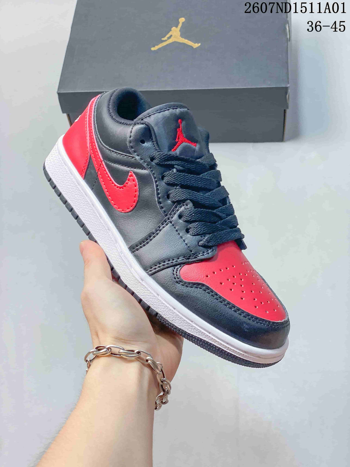 Angled view of a black and red low-top Jordan sneaker with white midsole
