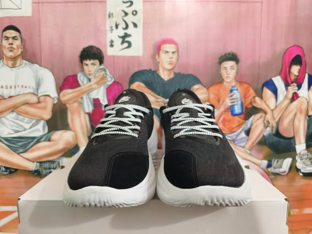 Front view showing black toes, patterned white laces, and white soles.