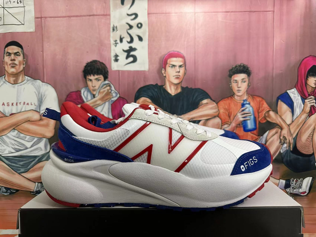 Side view of a white New Balance sneaker with red logo detailing, navy overlays, and a chunky sole.
