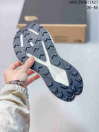 Close-up of the dark lugged outsole showing the trail-oriented tread pattern.