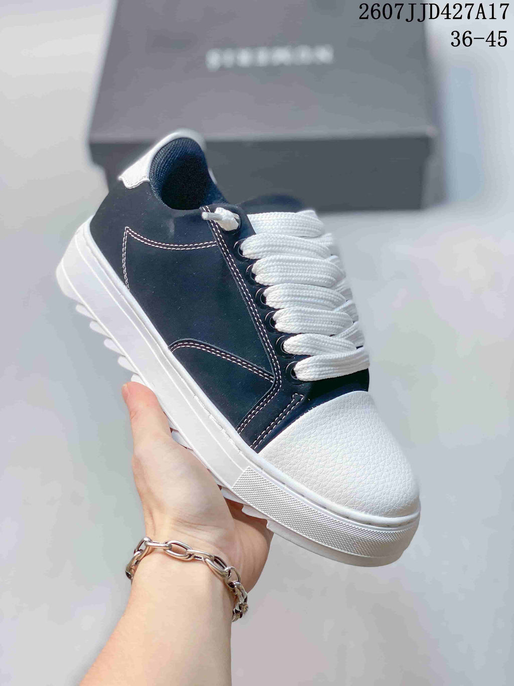 Angled side view of a navy and white Numeris sneaker showing the white toe cap, contrast stitching, laces, and outsole.