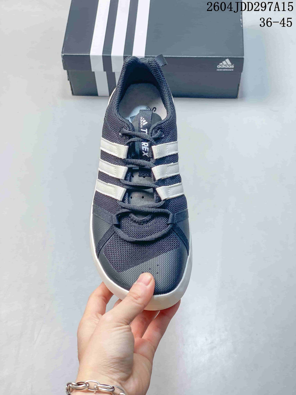 Top view of the shoe showing the mesh toe box, perforated detailing, lace closure, and three white stripes.
