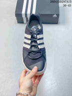 Top view of the shoe showing the mesh toe box, perforated detailing, lace closure, and three white stripes.
