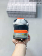 Rear view of the sneaker showing the orange heel band, padded collar and printed heel details.