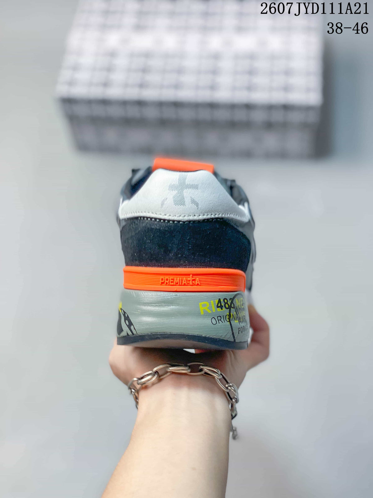 Rear view of the sneaker showing the orange heel band, padded collar and printed heel details.
