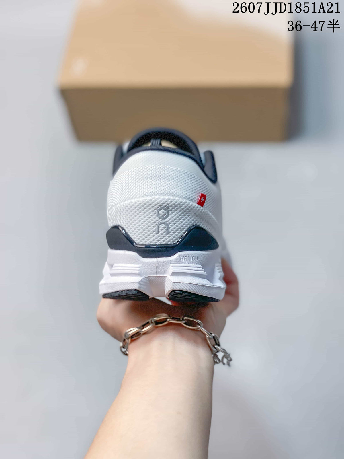 Rear view of the white sneaker showing the padded heel, dark heel detail, On branding, and small red accent.