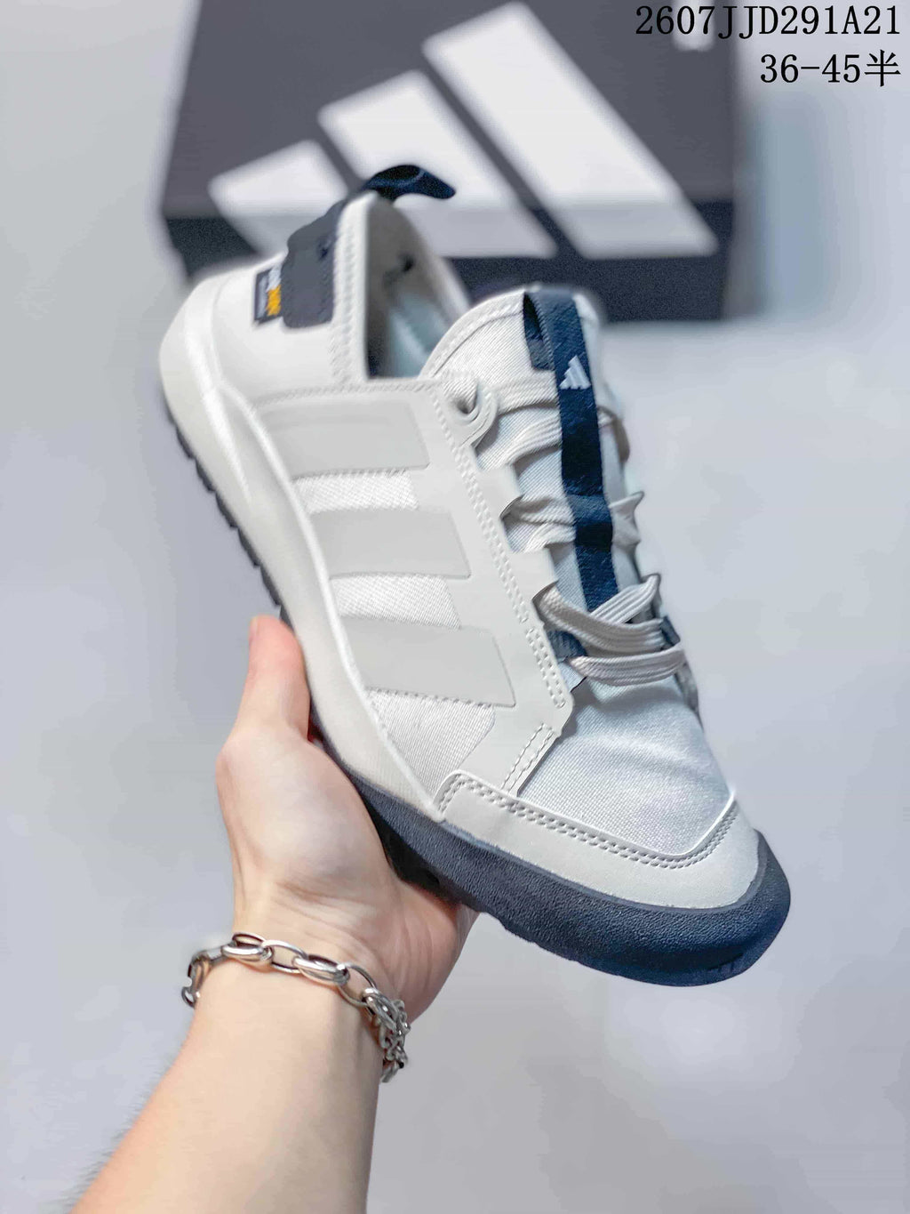 Angled side view highlighting the layered upper, heel pull tab and contrasting outsole.