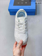 Top view of the white lace-up sneaker with a textured toe and padded collar.
