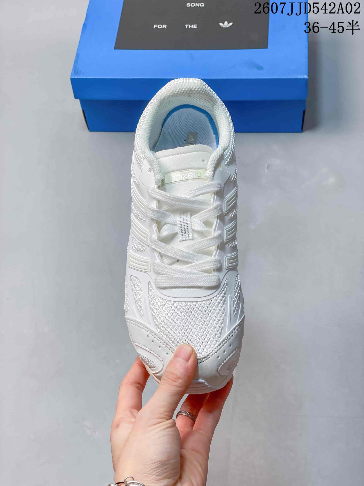 Top view of the white lace-up sneaker with a textured toe and padded collar.