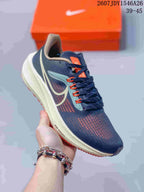 Angled side view of the navy Nike sneaker showing the Swoosh, orange accents, cream-colored midsole, and visible Zoom Air marking.