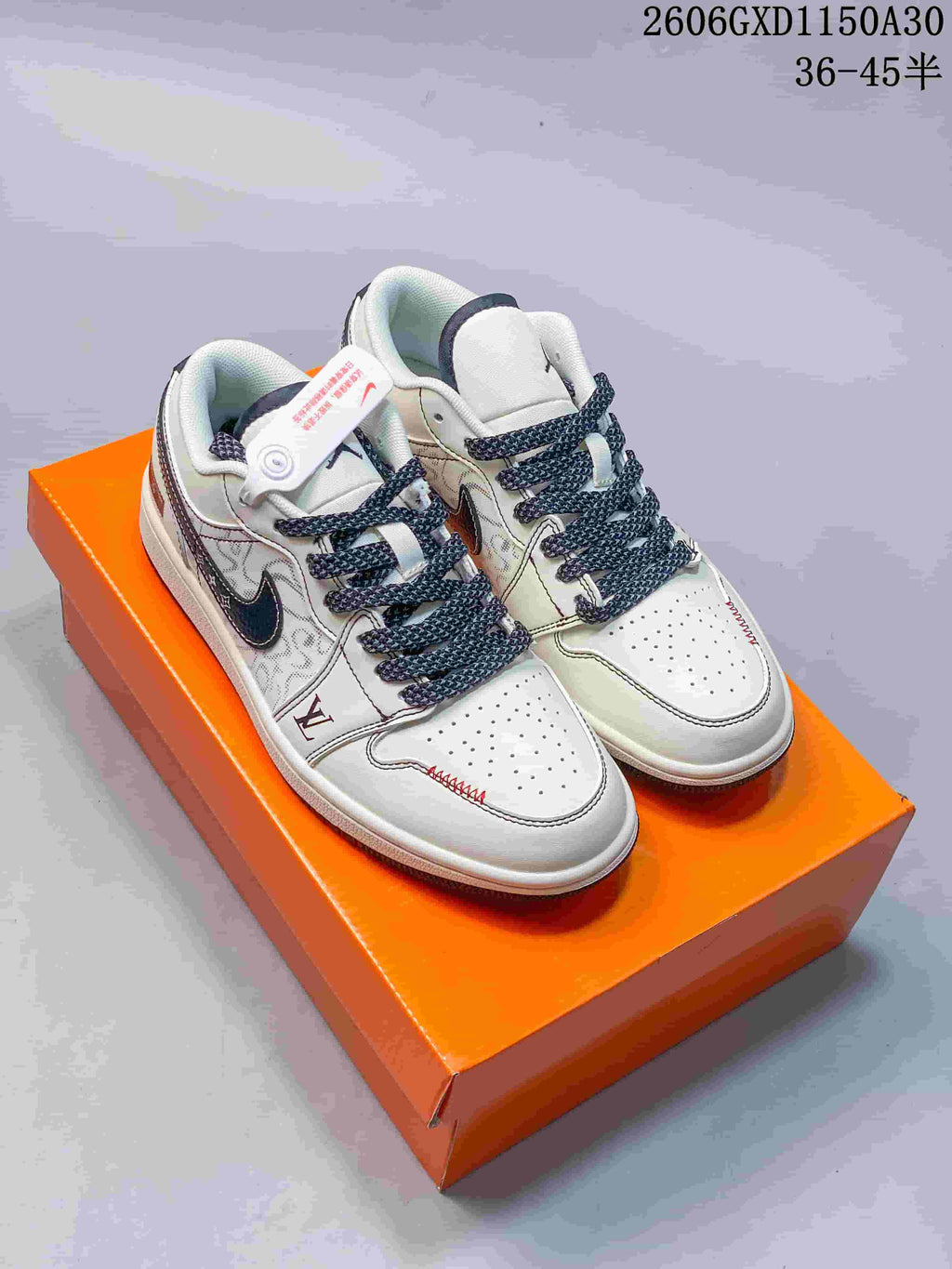 Pair of cream and dark navy Air Jordan 1 low-top sneakers with patterned panels and woven laces