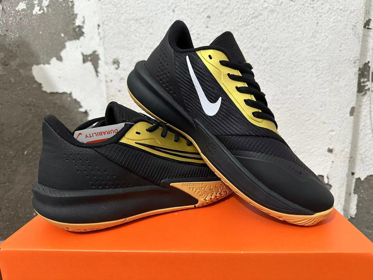 Pair of black and gold Nike Precision 7 basketball shoes shown from the side.
