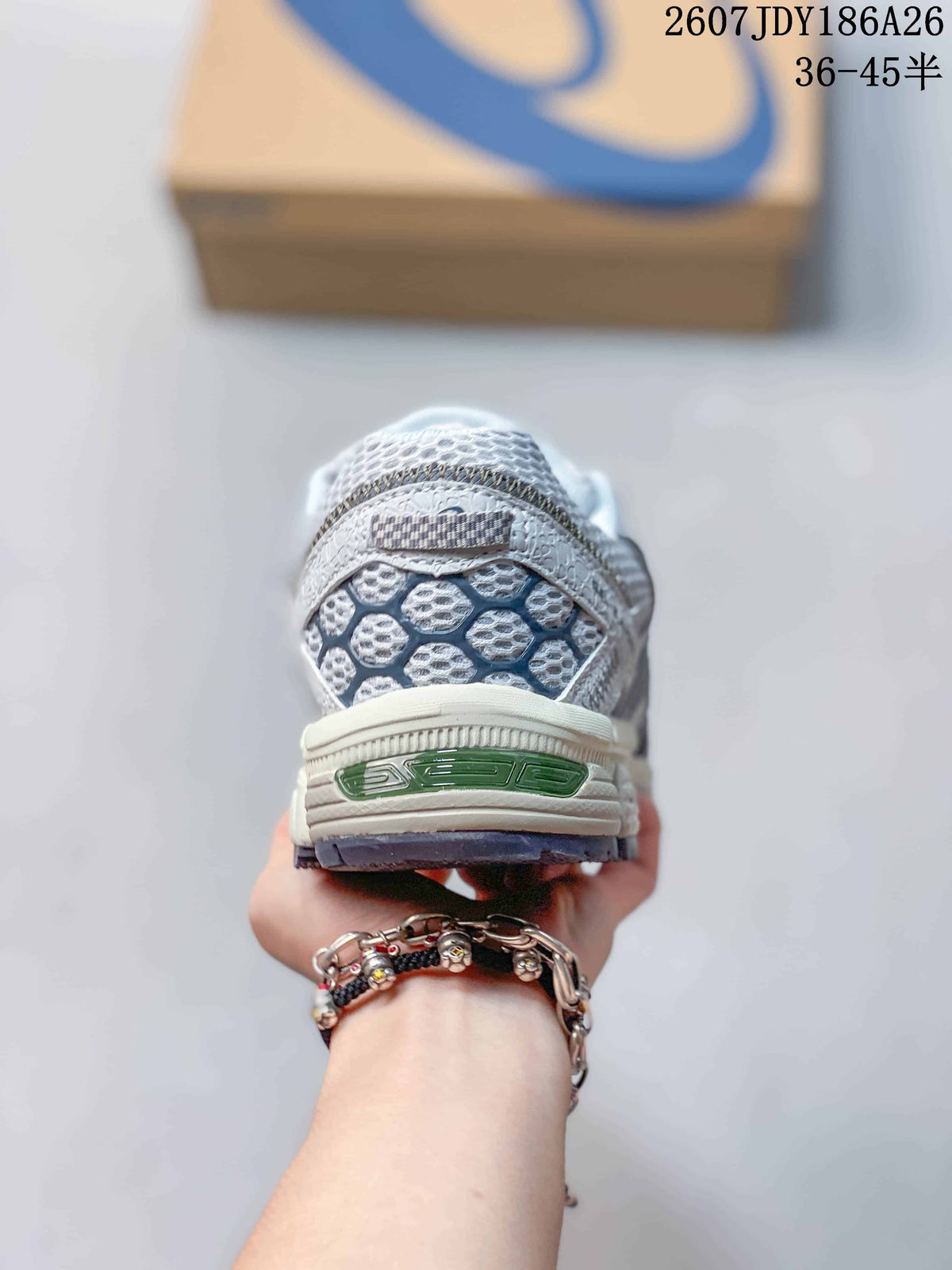Rear view of the ASICS sneaker showing the textured heel panel and layered sole construction.
