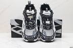 Front view of the paired sneakers showing black laces, grey mesh panels, and layered directional graphics.