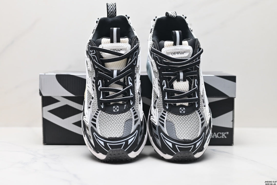 Front view of the paired sneakers showing black laces, grey mesh panels, and layered directional graphics.