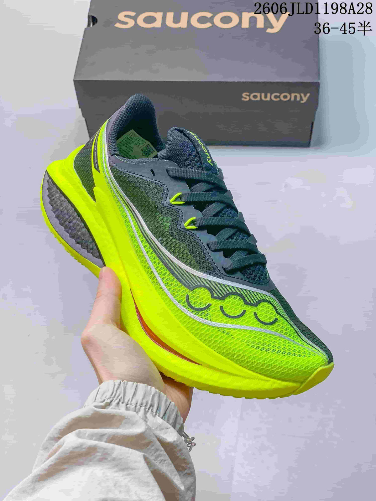 Angled side view highlighting the gray upper and bright yellow sole