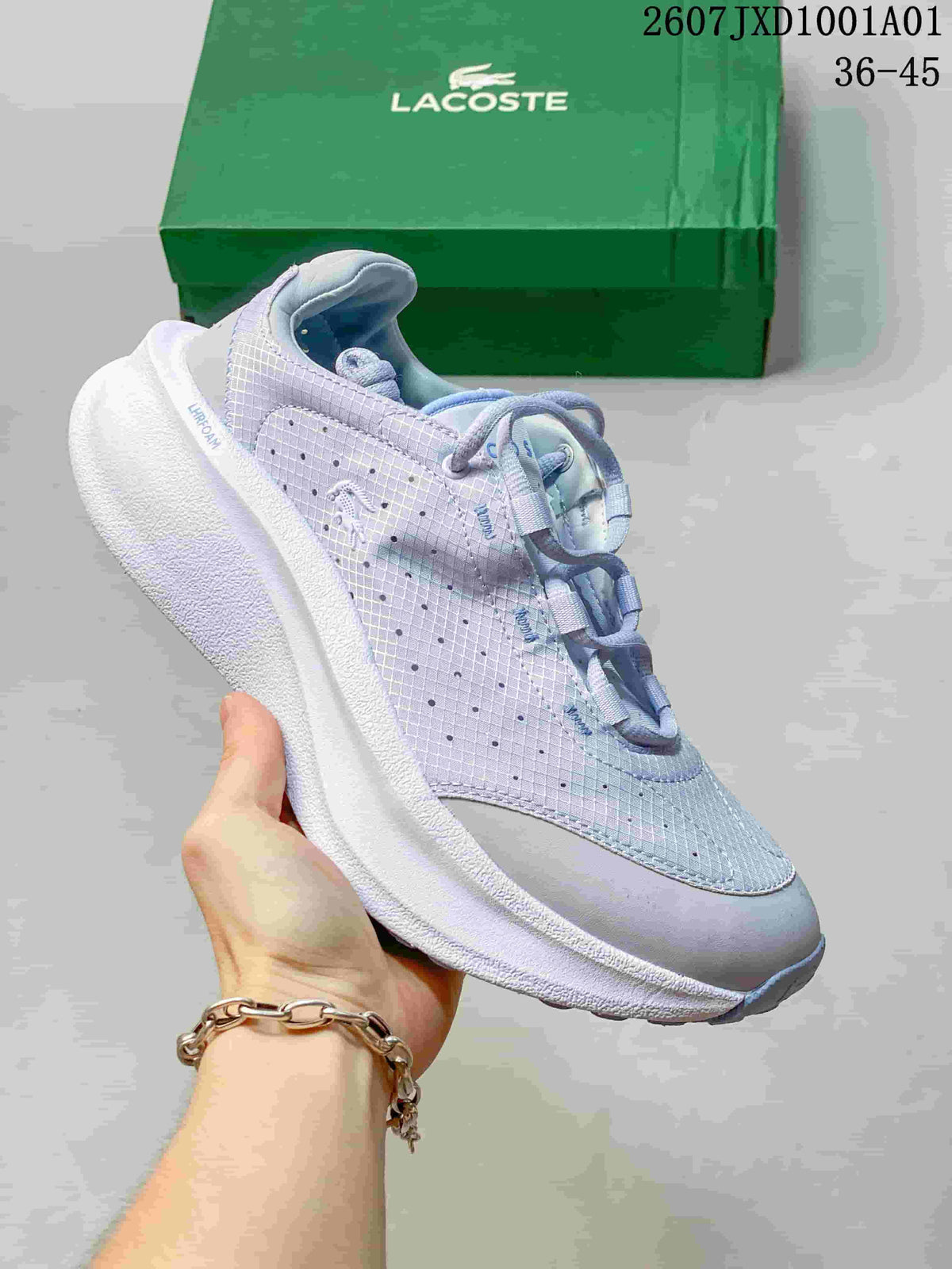 Pale lavender Lacoste lace-up sneaker with patterned upper and green shoebox